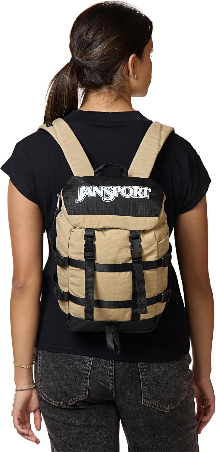 image:imageJanSport Mini Skip Pack Compact Backpack with Main Compartment Side Water Bottle Pocket and Zippered Accessory Pocket Red TapeTravertine